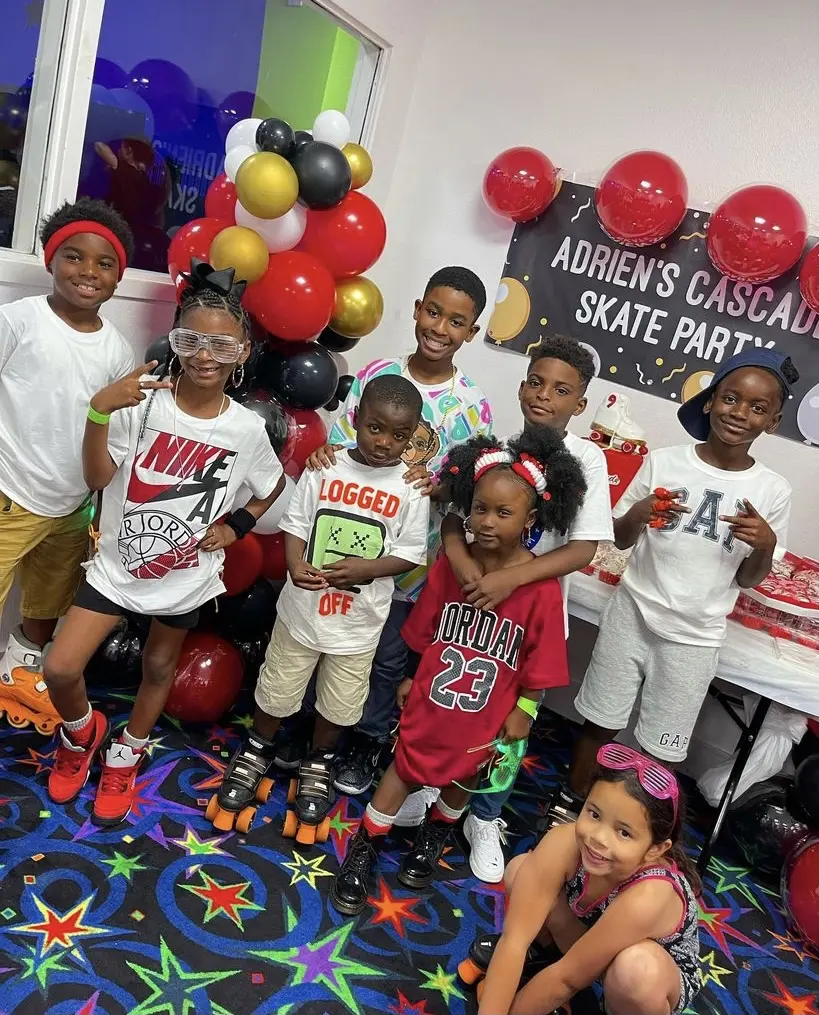 Smiling kids celebrating a roller skating birthday party at Arlington Skatium in the party room, in Arlington, Texas